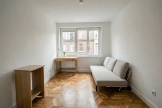 Intérieur d'un studio T1 en copropriété prêt à la vente avec parquet et kitchenette